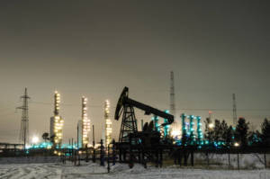 Oil Pump And Wellhead At The Background Of Refinery